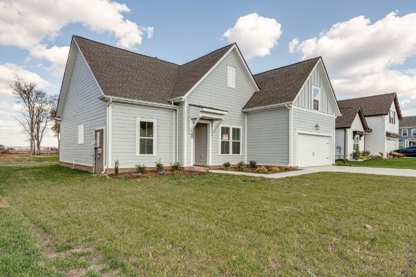 1125 Bermuda Chase St, Smyrna, TN 37167 - view of front of property with board and batten siding, a front lawn, concrete driveway, and an attached garage