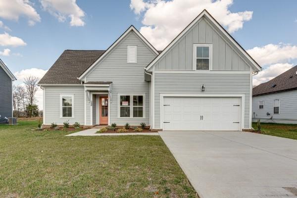 1125 Bermuda Chase St, Smyrna, TN 37167 - view of front of property featuring concrete driveway, a front yard, an attached garage, and board and batten siding