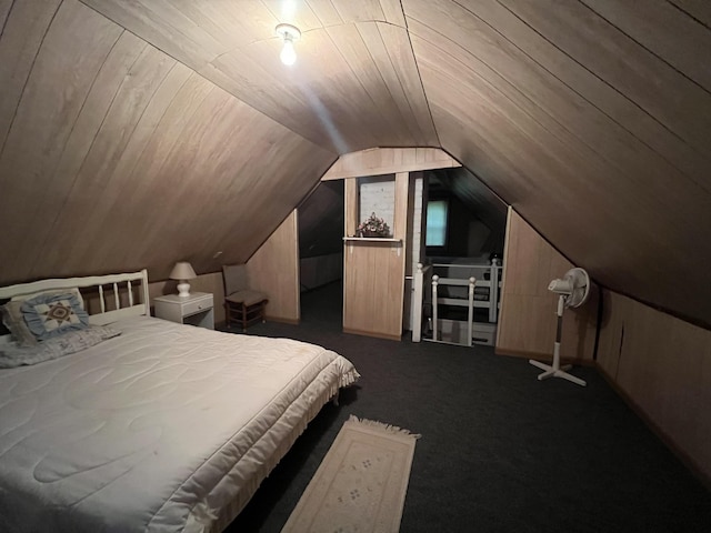 bedroom featuring dark colored carpet and vaulted ceiling