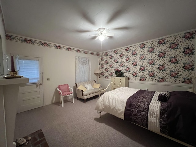 bedroom featuring carpet flooring, wallpapered walls, wainscoting, and ceiling fan