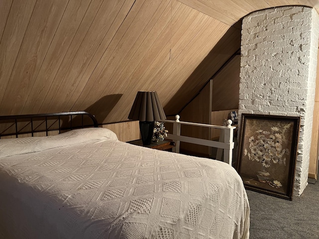 bedroom featuring lofted ceiling, wood walls, and carpet floors