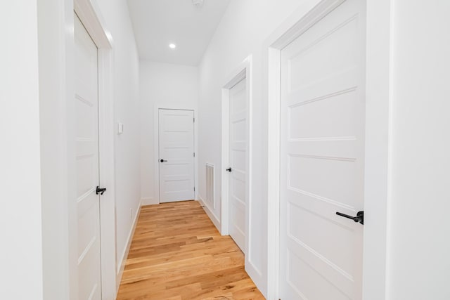 hallway with visible vents, light wood-type flooring, recessed lighting, and baseboards