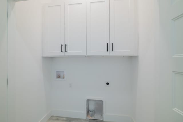 laundry area featuring electric dryer hookup, baseboards, cabinet space, and washer hookup