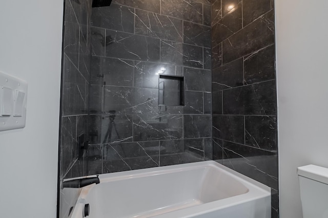 bathroom with shower / bathing tub combination and toilet