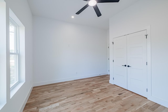 unfurnished bedroom with light wood finished floors, recessed lighting, a closet, ceiling fan, and baseboards