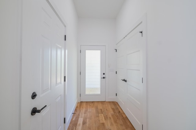 entryway with baseboards and light wood-style floors