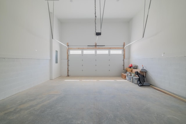 garage with a garage door opener and electric panel