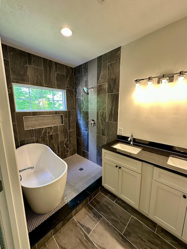 full bath featuring walk in shower, a sink, double vanity, marble finish floor, and a soaking tub