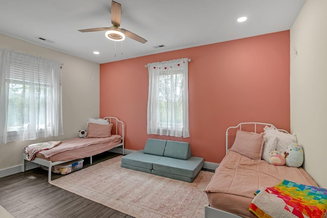 bedroom with recessed lighting, ceiling fan, visible vents, baseboards, and wood finished floors