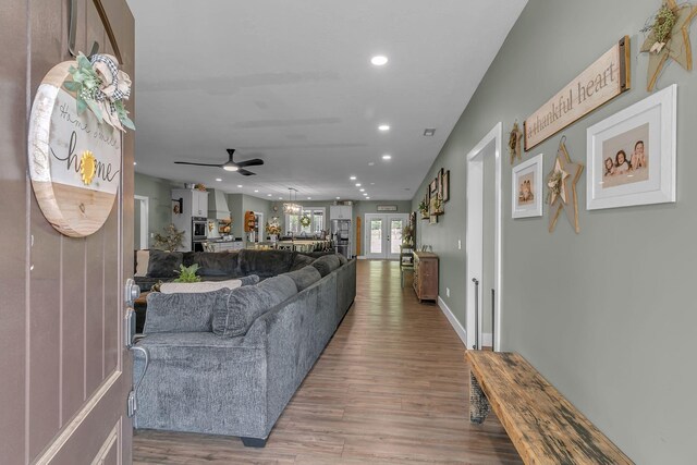 living room featuring recessed lighting, a ceiling fan, and wood finished floors
