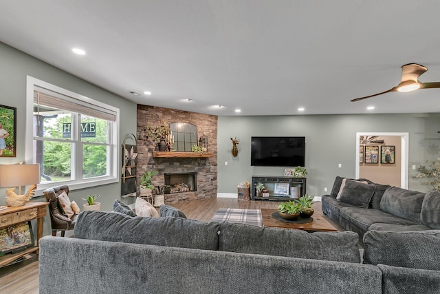 living room featuring recessed lighting, wood finished floors, ceiling fan, and a fireplace