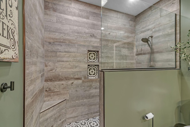 full bathroom featuring wooden walls and walk in shower