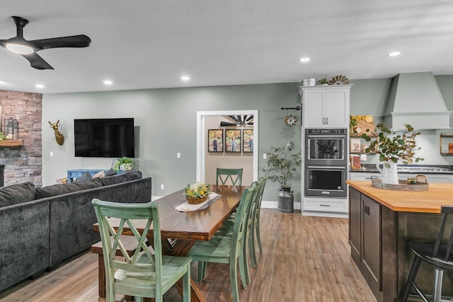 dining room featuring ceiling fan, recessed lighting, and light wood-style floors