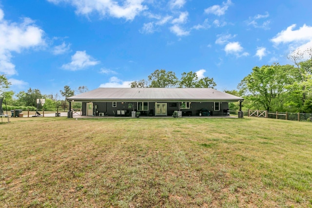 rear view of house featuring fence, a patio area, a yard, and french doors