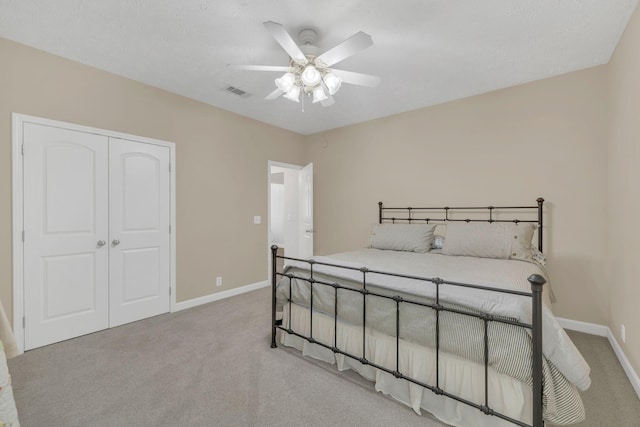 bedroom with baseboards, visible vents, carpet floors, and a closet