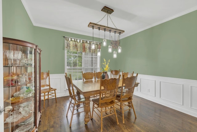 dining area with ornamental molding, dark wood-style flooring, and wainscoting