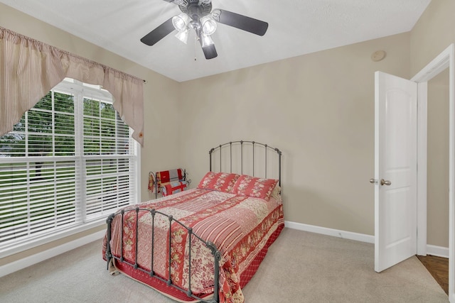 bedroom with baseboards, ceiling fan, and carpet flooring