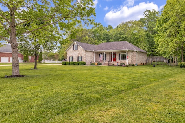 single story home featuring fence, a front yard, a porch, and brick siding