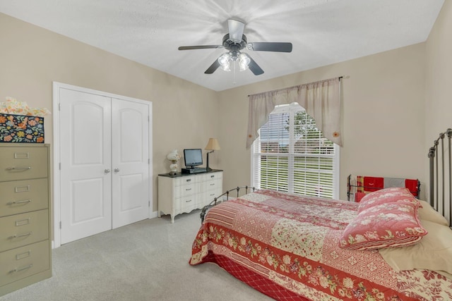 bedroom featuring a ceiling fan, a closet, and carpet flooring