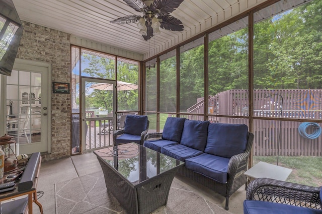 sunroom / solarium with a wealth of natural light, ceiling fan, and an outdoor living space
