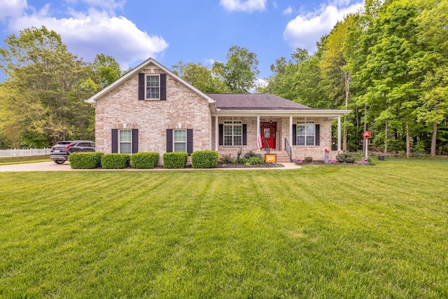 view of front of house with brick siding and a front lawn