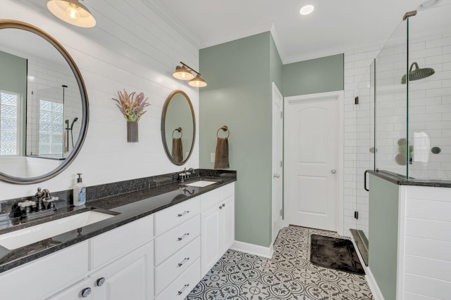 full bathroom with a shower stall, tile patterned flooring, crown molding, and a sink