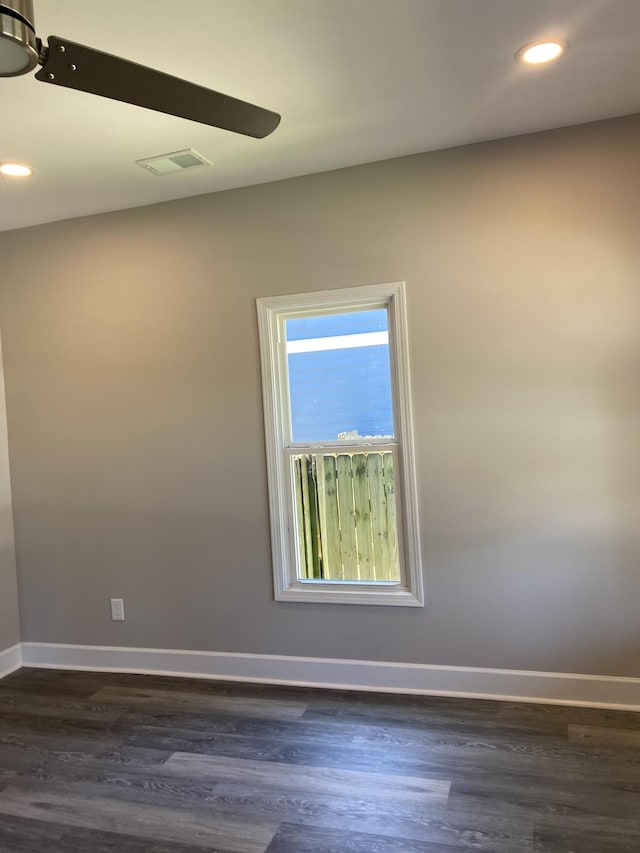 empty room featuring visible vents, recessed lighting, dark wood finished floors, and baseboards