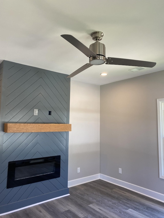details with wood finished floors, a fireplace, baseboards, visible vents, and a ceiling fan