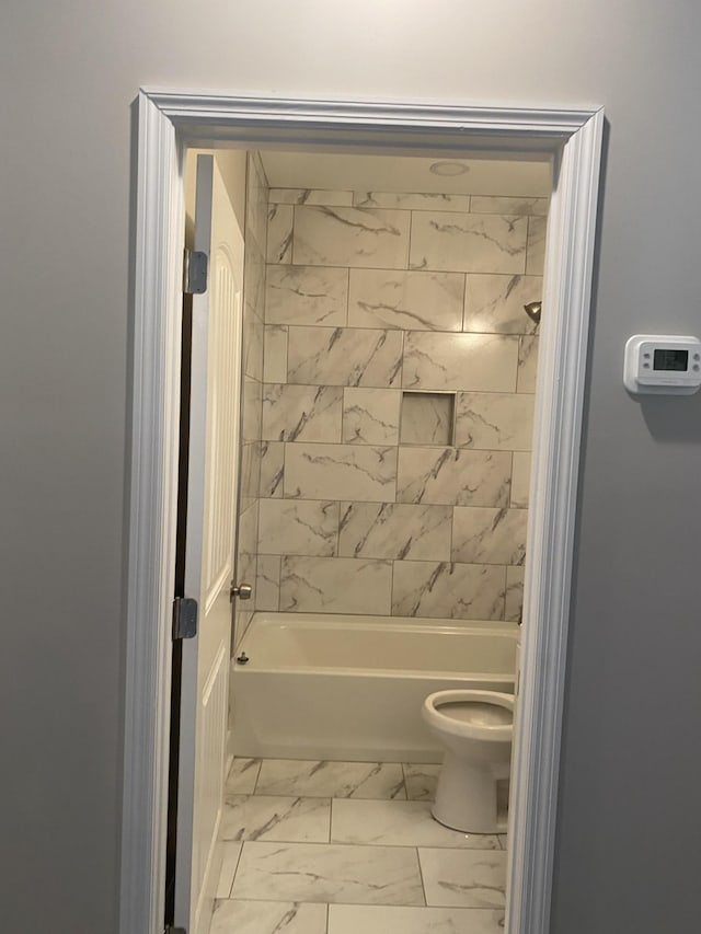 full bath featuring toilet, marble finish floor, and shower / bathtub combination