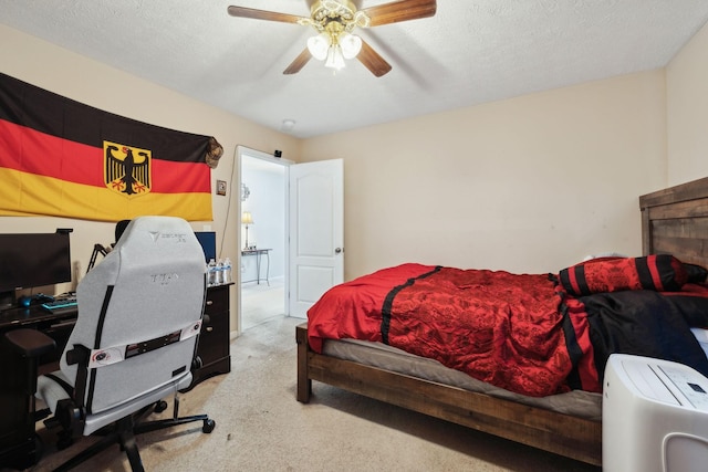 bedroom with carpet, a ceiling fan, and a textured ceiling