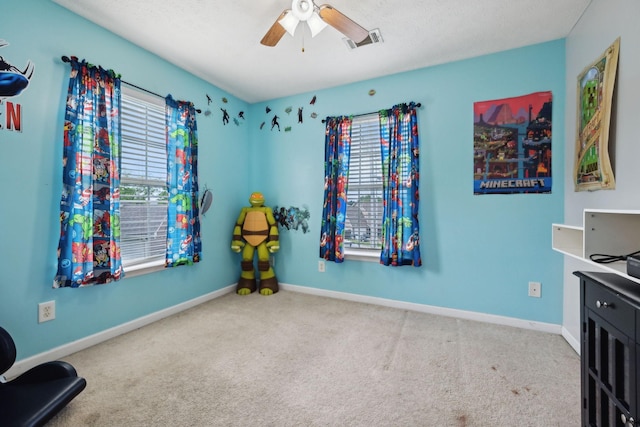 rec room with carpet, visible vents, a ceiling fan, and baseboards