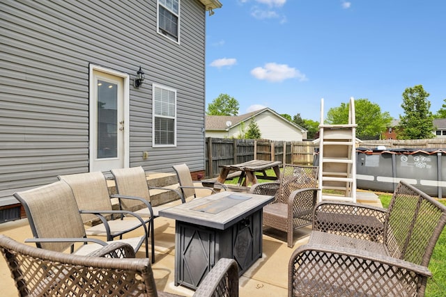 view of patio featuring a fire pit and a fenced backyard