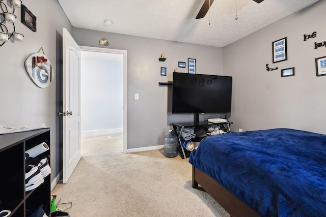 bedroom with ceiling fan, carpet floors, and baseboards