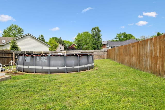 view of yard with a fenced in pool and a fenced backyard
