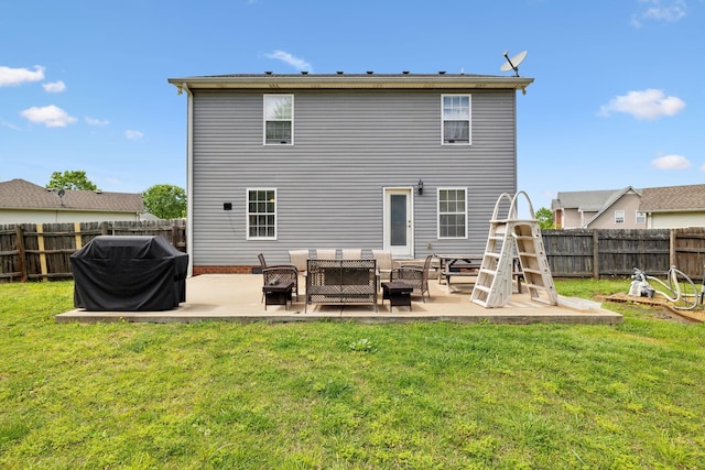 back of house featuring a patio, an outdoor living space, a fenced backyard, and a yard