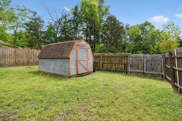view of yard with a storage unit, a fenced backyard, and an outdoor structure