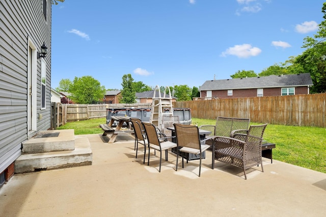 view of patio featuring outdoor dining area and a fenced backyard