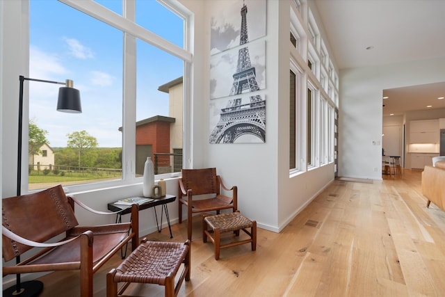 corridor with baseboards, recessed lighting, and wood finished floors