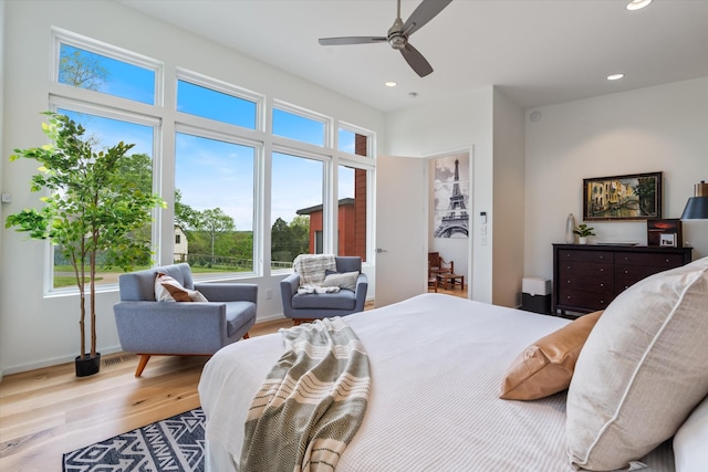 bedroom with wood finished floors, recessed lighting, a ceiling fan, and baseboards