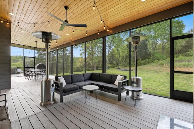 sunroom with an outdoor hangout area, a ceiling fan, track lighting, and a healthy amount of sunlight