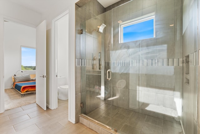 ensuite bathroom featuring toilet, a shower stall, and ensuite bathroom
