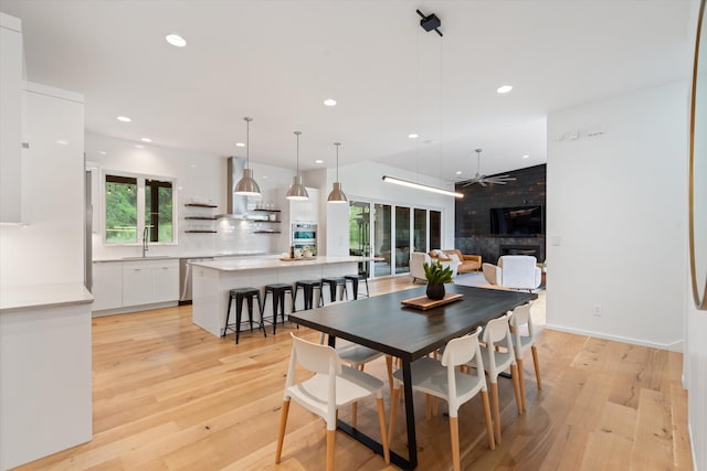 dining space featuring light wood-type flooring, recessed lighting, and a ceiling fan