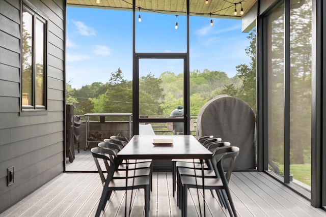 sunroom with outdoor dining area