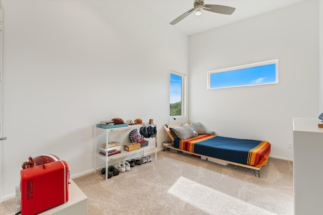 carpeted bedroom featuring ceiling fan and baseboards