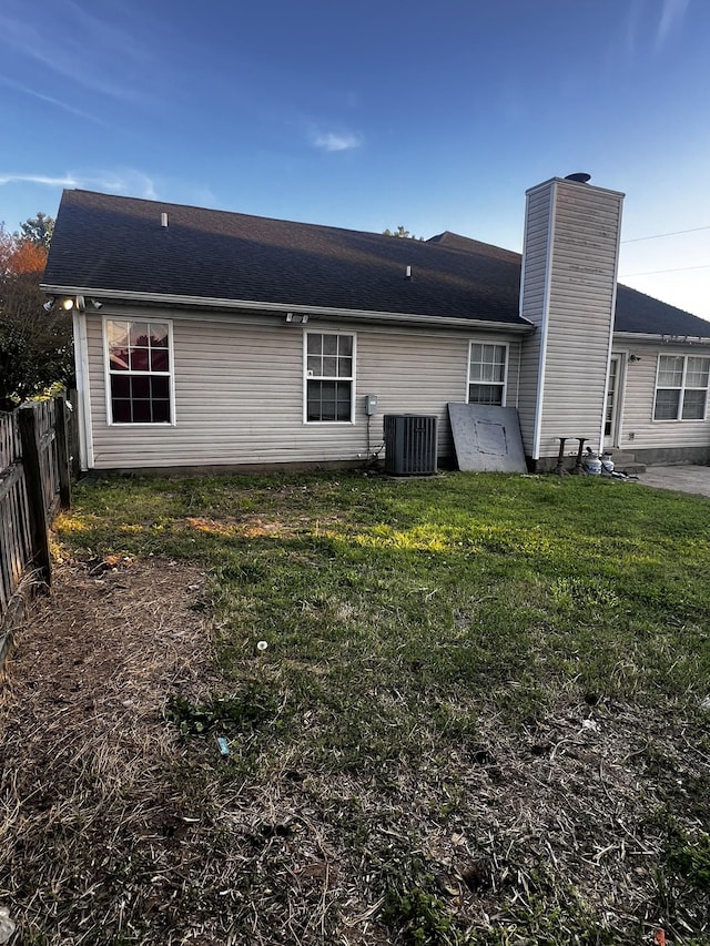 914 Lavergne Ln, La Vergne, TN 37086 - back of house with central AC, fence, a chimney, and a lawn