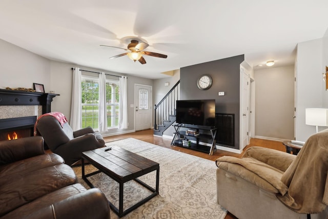 108 Braley Ct, Murfreesboro, TN 37129 - living area featuring stairway, a ceiling fan, a tiled fireplace, and wood finished floors