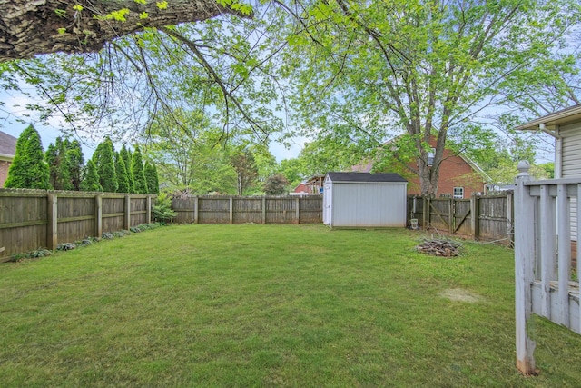 view of yard featuring a fenced backyard, an outbuilding, and a storage shed