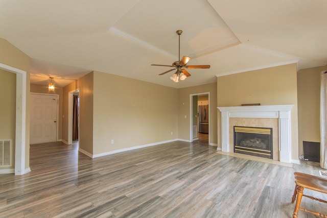 unfurnished living room with lofted ceiling, wood finished floors, ceiling fan, and a fireplace