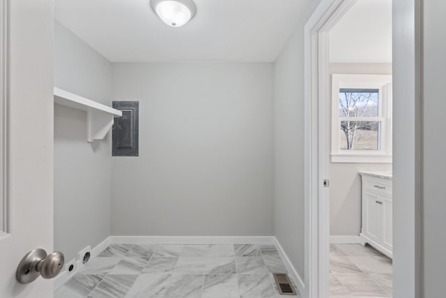 washroom with electric panel, laundry area, marble finish floor, visible vents, and baseboards