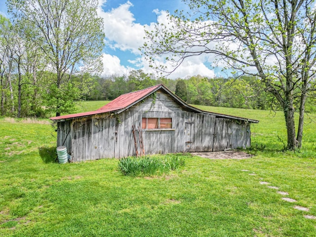 view of barn with a lawn